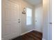 Inviting foyer featuring a stylish key rack, a window, and sleek wood-look flooring at 3367 Rolling Knoll Ln, Columbus, IN 47201