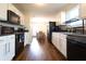 The kitchen features modern black appliances, white cabinetry, and ample counter space at 3367 Rolling Knoll Ln, Columbus, IN 47201