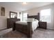 Spacious main bedroom with ample natural light, a large bed, and a dresser with a mirror at 3367 Rolling Knoll Ln, Columbus, IN 47201
