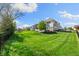 A lush backyard with a manicured lawn and a charming patio, complete with a fire pit and play equipment at 3561 Shady Lk Dr, Westfield, IN 46074