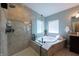 Luxurious bathroom with a stand-up shower and soaking tub next to a sunlit window for ultimate relaxation at 3561 Shady Lk Dr, Westfield, IN 46074