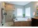 Beautiful bathroom featuring a tiled stand-up shower and an adjacent soaking tub with a view at 3561 Shady Lk Dr, Westfield, IN 46074