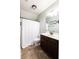 Cozy bathroom with a white shower curtain, dark wood vanity, and a coordinated mirror at 3561 Shady Lk Dr, Westfield, IN 46074