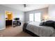 Bedroom with grey walls, light carpet, ensuite bathroom access, and a study desk at 3561 Shady Lk Dr, Westfield, IN 46074