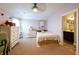 Bright bedroom features a ceiling fan, soft carpet, light pink walls, and ensuite bathroom access at 3561 Shady Lk Dr, Westfield, IN 46074