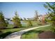 A winding path leads to a gazebo by a lake, surrounded by well-maintained lawns and houses at 3561 Shady Lk Dr, Westfield, IN 46074