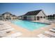 A pristine community pool with ample lounge seating and a nearby clubhouse, perfect for relaxation and recreation at 3561 Shady Lk Dr, Westfield, IN 46074