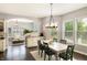 Bright dining room with a large window, hardwood floors, and a modern chandelier at 3561 Shady Lk Dr, Westfield, IN 46074