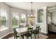 Open dining area with a large window, wood table, and a modern chandelier at 3561 Shady Lk Dr, Westfield, IN 46074
