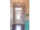 Bright foyer features a modern light fixture, front door wreath, and pristine white trim at 3561 Shady Lk Dr, Westfield, IN 46074