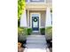 Inviting front door with wreath, flanked by ferns, on stone-accented porch at 3561 Shady Lk Dr, Westfield, IN 46074