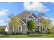 Charming two-story home with gray siding, stone accents, well-manicured lawn, and a welcoming front porch at 3561 Shady Lk Dr, Westfield, IN 46074