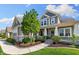 Charming two-story home featuring manicured landscaping and inviting front porch at 3561 Shady Lk Dr, Westfield, IN 46074