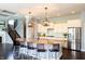 Open-concept kitchen boasts a granite island, modern appliances, and stylish pendants at 3561 Shady Lk Dr, Westfield, IN 46074