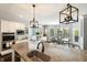 Open kitchen with granite countertops, white cabinets, and stainless steel appliances at 3561 Shady Lk Dr, Westfield, IN 46074