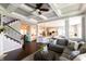 Open-concept living room with a modern staircase and connected kitchen at 3561 Shady Lk Dr, Westfield, IN 46074