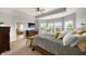 Serene main bedroom boasts a large window, tray ceiling, and a view into the spa-like ensuite bathroom at 3561 Shady Lk Dr, Westfield, IN 46074