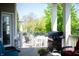 Covered outdoor patio featuring a table and chairs, grill, and comfortable seating perfect for entertaining at 3561 Shady Lk Dr, Westfield, IN 46074