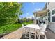 Back patio with a white table and six chairs and a view of the play set in the back yard at 3561 Shady Lk Dr, Westfield, IN 46074