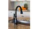 Close up of a bronze kitchen faucet and sink with granite countertops at 3561 Shady Lk Dr, Westfield, IN 46074