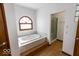 Spacious bathroom with a soaking tub and a separate glass-enclosed shower at 3948 S Woodfield Dr, New Palestine, IN 46163