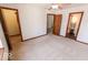 Spacious bedroom featuring plush carpeting, a ceiling fan, and multiple doorways, enhancing its versatility at 3948 S Woodfield Dr, New Palestine, IN 46163
