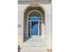 Inviting entryway featuring a stylish blue front door with sidelights and arched transom window at 3948 S Woodfield Dr, New Palestine, IN 46163