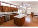 Charming kitchen with granite counters, wooden cabinets, and an island with an attached table at 3948 S Woodfield Dr, New Palestine, IN 46163