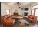 Stylish living room featuring a cozy fireplace, comfortable leather seating, and natural light at 3948 S Woodfield Dr, New Palestine, IN 46163