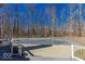 Large inground pool with gated deck and a forest backdrop, for luxurious outdoor living at 3948 S Woodfield Dr, New Palestine, IN 46163