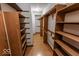 Spacious walk-in closet with wooden shelves and hanging racks for optimal storage at 3948 S Woodfield Dr, New Palestine, IN 46163