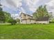 Large, well-maintained lawn and backyard with mature trees and access to detached garage at 4079 S 50 W, Anderson, IN 46013