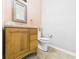 Powder room features a wood vanity and toilet at 4079 S 50 W, Anderson, IN 46013