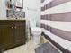 Bathroom featuring a vanity, toilet, tile floor and a shower with a striped curtain at 4079 S 50 W, Anderson, IN 46013