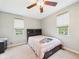 Neutral bedroom featuring a ceiling fan, carpeted floor, and natural light from two windows at 4079 S 50 W, Anderson, IN 46013