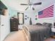 Bedroom featuring light blue walls, carpeted floor, ceiling fan, and a white metal bed frame at 4079 S 50 W, Anderson, IN 46013