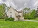 Charming two-story home with yellow siding, a covered porch, and a well-maintained lawn at 4079 S 50 W, Anderson, IN 46013