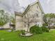 Charming exterior view showcasing a well-maintained lawn with garden beds and a charming porch at 4079 S 50 W, Anderson, IN 46013