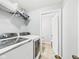 Bright laundry room featuring modern front load machines and access to a half bathroom at 4079 S 50 W, Anderson, IN 46013