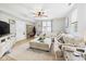 Cozy living room featuring a large sectional couch, a ceiling fan, and a view of the entrance at 4079 S 50 W, Anderson, IN 46013