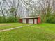 Detached outbuilding with two garage doors and a side entry door in a grassy area at 4079 S 50 W, Anderson, IN 46013
