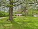 Outbuilding surrounded by mature trees and a lush, grassy area at 4079 S 50 W, Anderson, IN 46013
