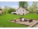 A spacious backyard features a deck, grill, and a fire pit area with wooden benches, perfect for outdoor gatherings and relaxation at 4091 W Briarwood Lake S Dr, Monrovia, IN 46157