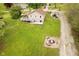 Expansive backyard featuring a charming patio, fire pit, and lush green lawn perfect for outdoor enjoyment at 4091 W Briarwood Lake S Dr, Monrovia, IN 46157