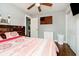 Comfortable bedroom featuring wood accents, a ceiling fan, and a large window at 4091 W Briarwood Lake S Dr, Monrovia, IN 46157