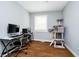 Cozy room featuring hardwood floors, a dedicated desk, a computer station, and natural light at 4091 W Briarwood Lake S Dr, Monrovia, IN 46157