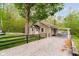 A charming home with a covered carport, gravel driveway and a black fence at 4091 W Briarwood Lake S Dr, Monrovia, IN 46157