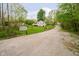 A cozy single-story home with a well-maintained lawn, a quaint deck, and a gravel driveway, exuding rural charm and tranquility at 4091 W Briarwood Lake S Dr, Monrovia, IN 46157