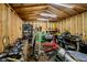 Mechanic garage interior view showcasing wooden walls, fluorescent lighting, tools, a green toolbox, and a car engine on a stand at 4091 W Briarwood Lake S Dr, Monrovia, IN 46157