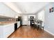 Modern kitchen with white cabinets, updated appliances, and wood flooring at 4091 W Briarwood Lake S Dr, Monrovia, IN 46157